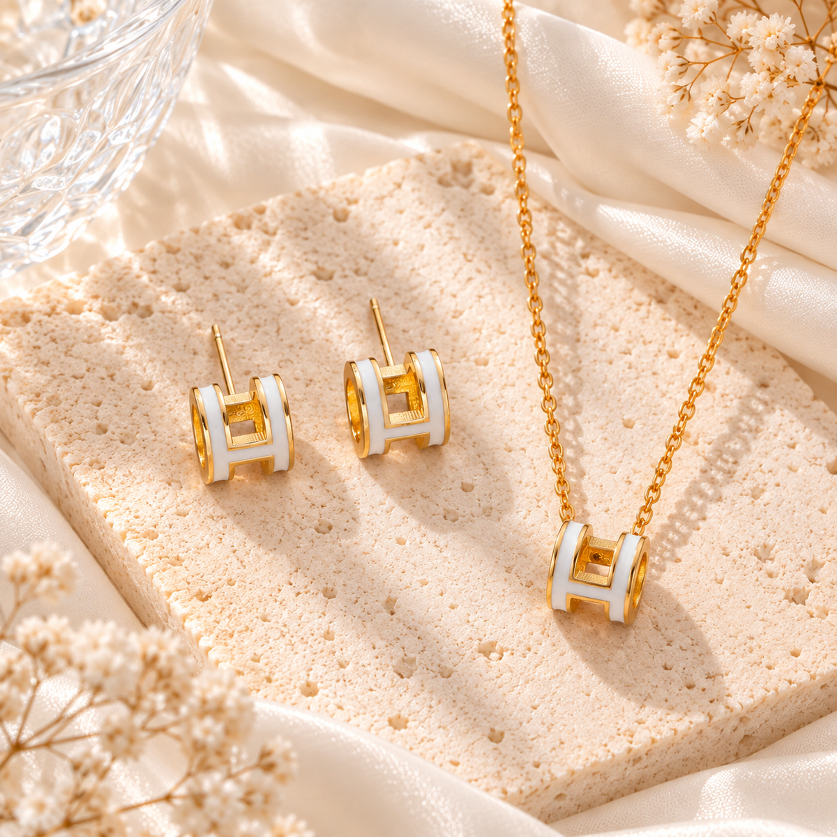 white and gold h set earrings and necklace