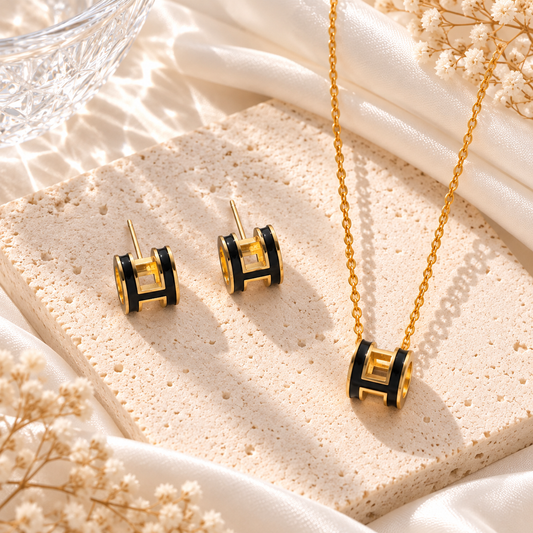 black and gold h set earrings and necklace